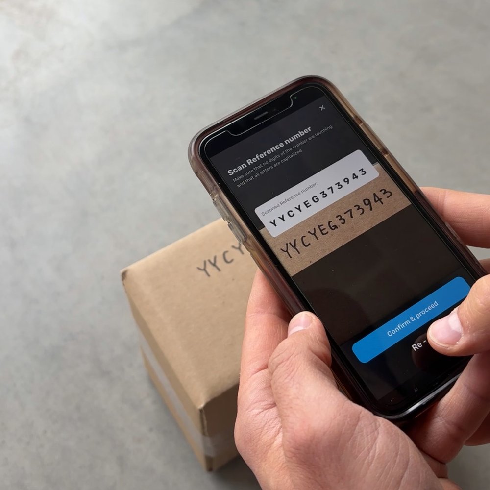 Phone app reading the handwritten reference number on a parcel